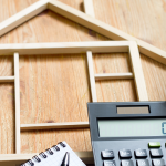 wood house frame and a calculator