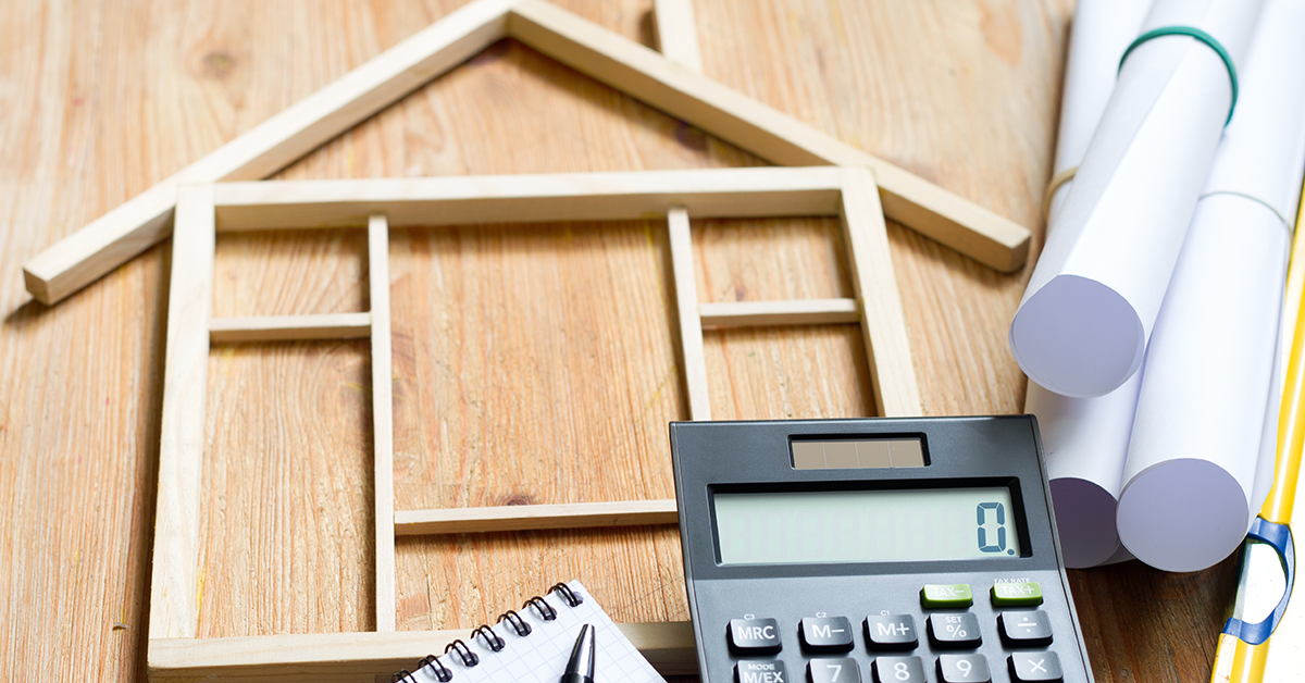 wood house frame and a calculator